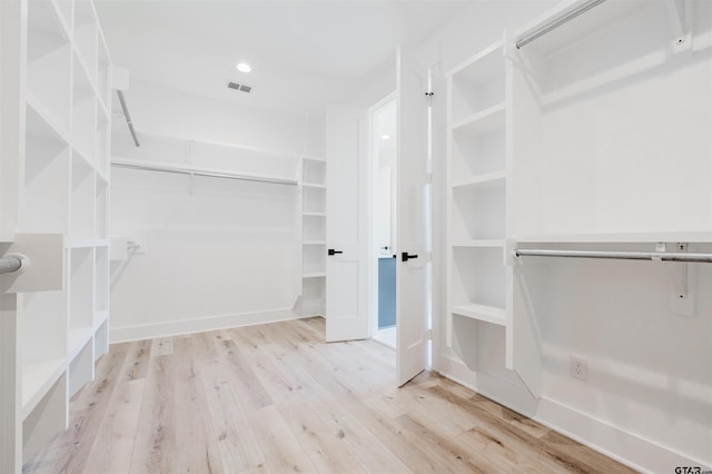 walk in closet featuring visible vents and wood finished floors