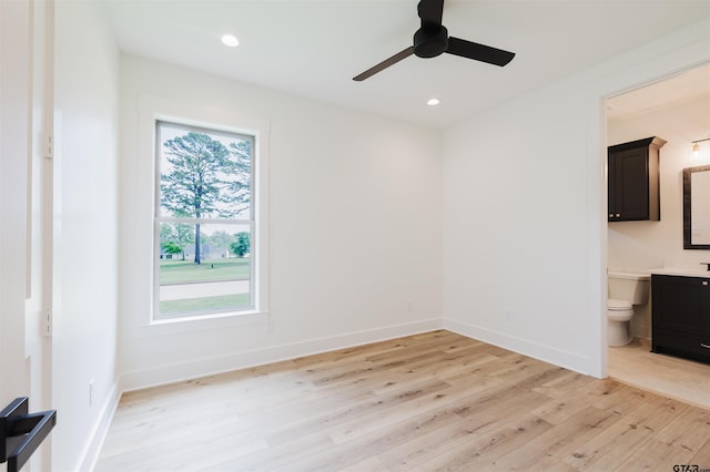 unfurnished bedroom with baseboards, ensuite bathroom, recessed lighting, and light wood-style flooring