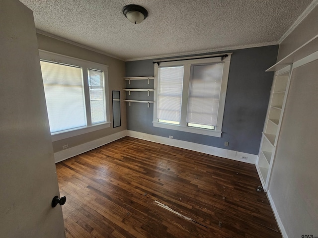 205 E Emma St, Bullard, TX 75757 - spare room with ornamental molding, a wealth of natural light, a textured ceiling, and dark wood-type flooring
