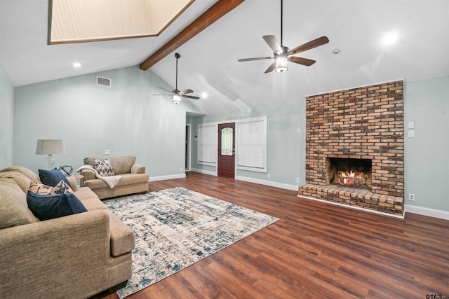 living room with ceiling fan, a fireplace, lofted ceiling with beams, and hardwood / wood-style flooring