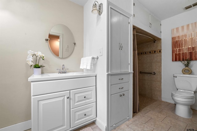 bathroom with a tile shower, tile patterned floors, vanity, and toilet