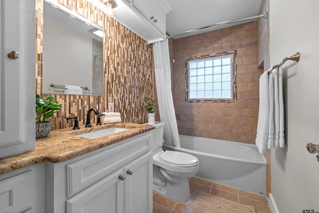 full bathroom featuring tile patterned flooring, shower / bath combo, vanity, and toilet