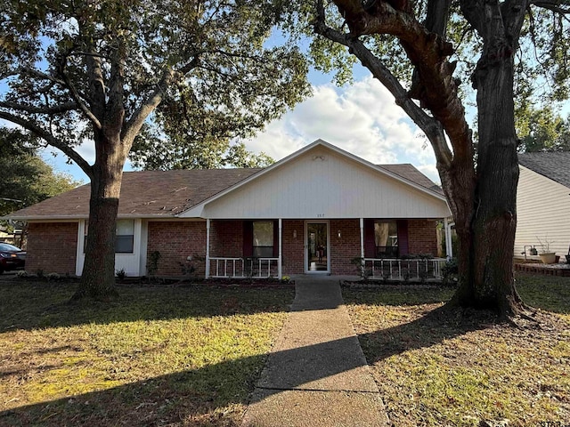 single story home featuring a front lawn and covered porch