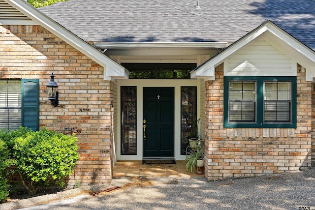 177 Paint Rock Pt, Holly Lake Ranch, TX 75765 - view of exterior entry with brick siding and roof with shingles