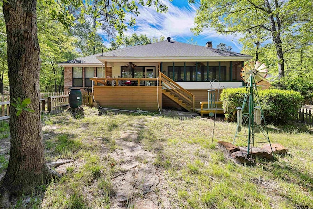 177 Paint Rock Pt, Holly Lake Ranch, TX 75765 - rear view of house with fence, a chimney, a sunroom, and stairway