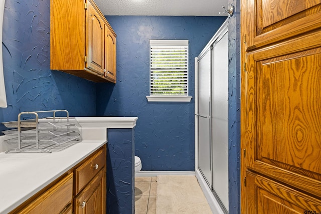 177 Paint Rock Pt, Holly Lake Ranch, TX 75765 - bathroom with vanity, toilet, tile patterned floors, baseboards, and a shower stall