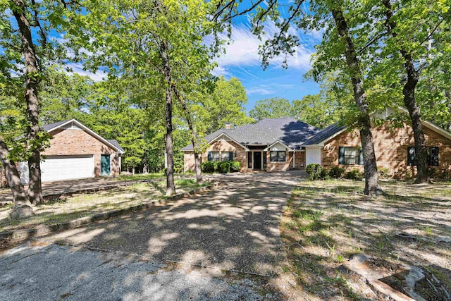 177 Paint Rock Pt, Holly Lake Ranch, TX 75765 - single story home with brick siding, a chimney, and aphalt driveway