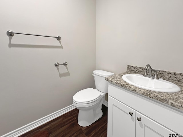 bathroom with vanity, wood-type flooring, and toilet