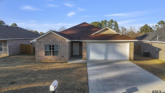 ranch-style house with cooling unit and a garage