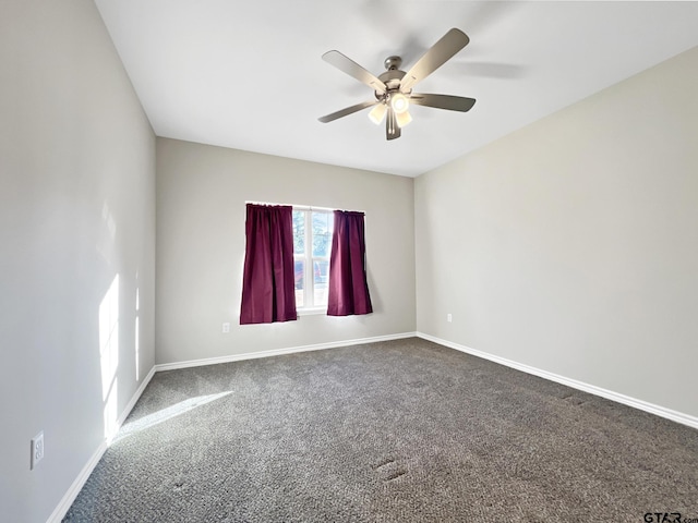 unfurnished room with ceiling fan and carpet