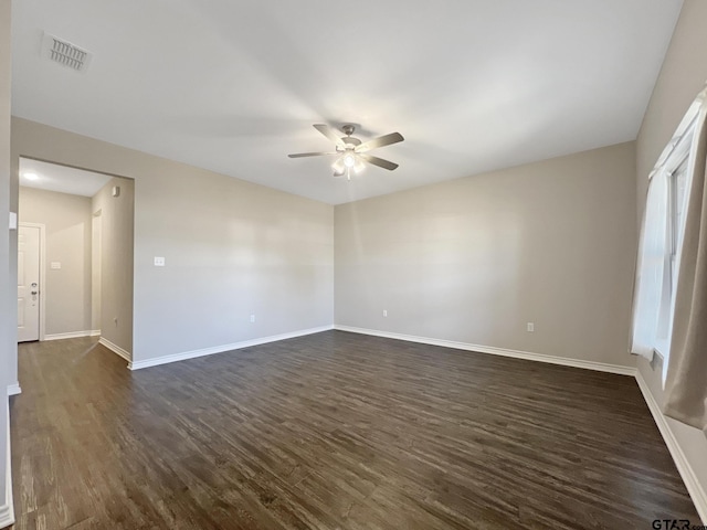 unfurnished room with dark wood-type flooring and ceiling fan