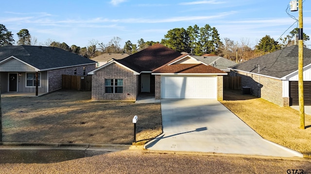 ranch-style home featuring a garage, a front lawn, and central air condition unit