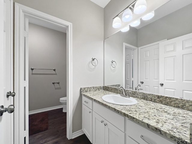 bathroom featuring hardwood / wood-style flooring, vanity, and toilet