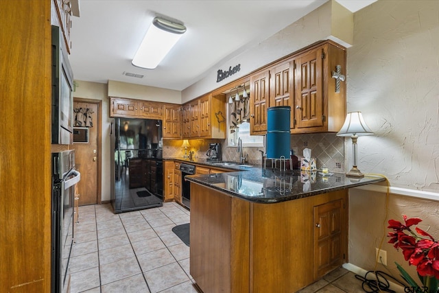 kitchen with kitchen peninsula, black appliances, sink, light tile patterned floors, and backsplash