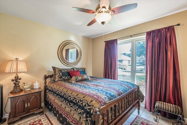 tiled bedroom featuring ceiling fan