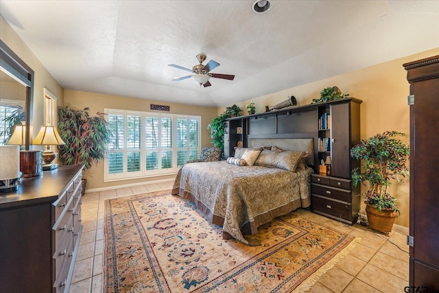 tiled bedroom featuring a textured ceiling and ceiling fan