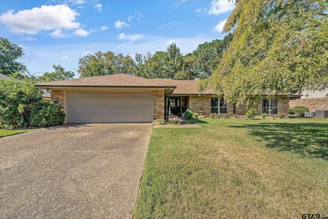 single story home featuring a garage and a front yard