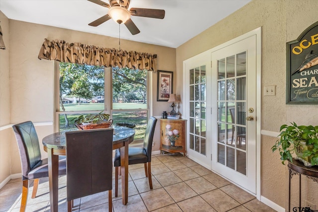 dining area with light tile patterned floors and ceiling fan