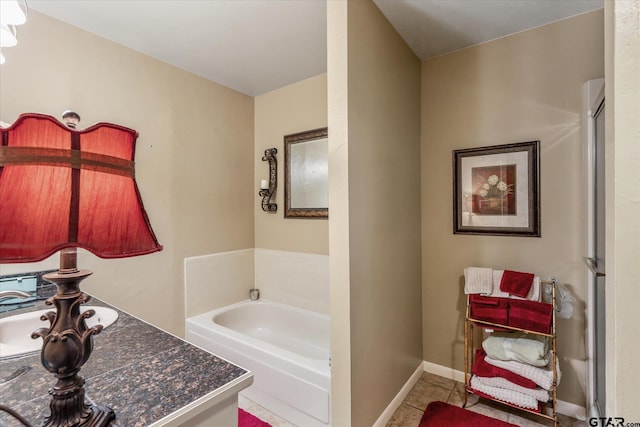 bathroom with a bath and tile patterned flooring