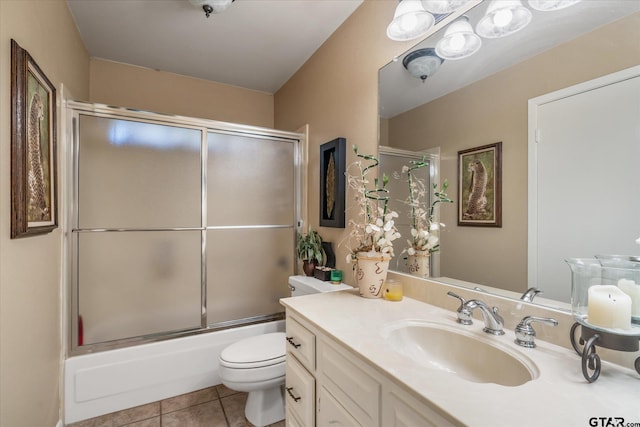 full bathroom featuring toilet, vanity, tile patterned flooring, and enclosed tub / shower combo