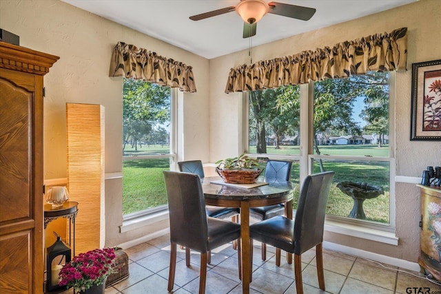 dining space with plenty of natural light, ceiling fan, and light tile patterned flooring