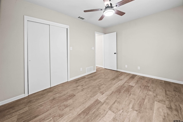 unfurnished bedroom with a closet, light wood-type flooring, and ceiling fan