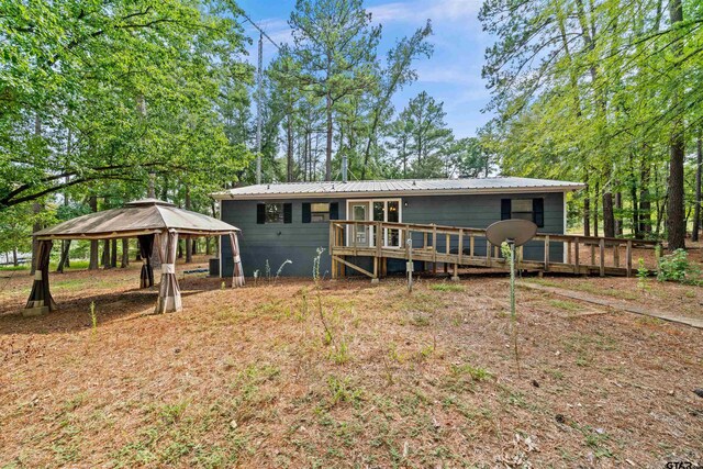 back of house with a deck and a gazebo