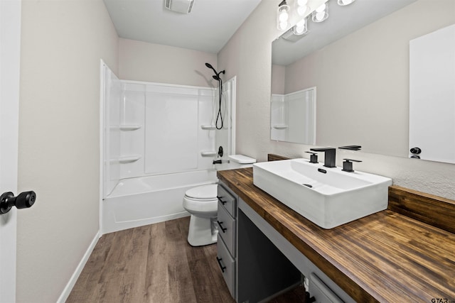 full bathroom with toilet, wood-type flooring, vanity, and shower / bathtub combination