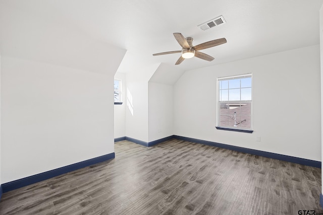 bonus room featuring vaulted ceiling, wood finished floors, visible vents, and baseboards