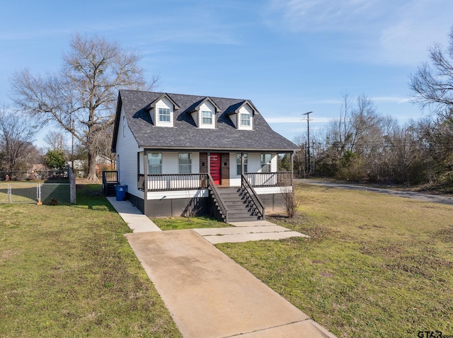 view of front of house featuring covered porch, stairs, a front lawn, and roof with shingles