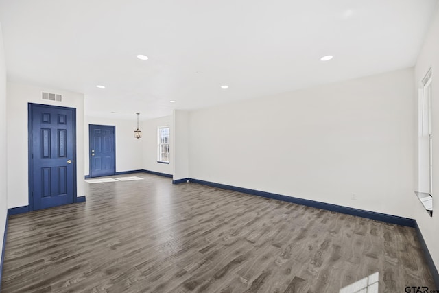 interior space featuring recessed lighting, visible vents, baseboards, and wood finished floors