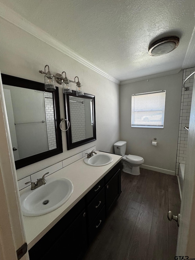 full bath featuring a textured ceiling, wood finished floors, a sink, and toilet