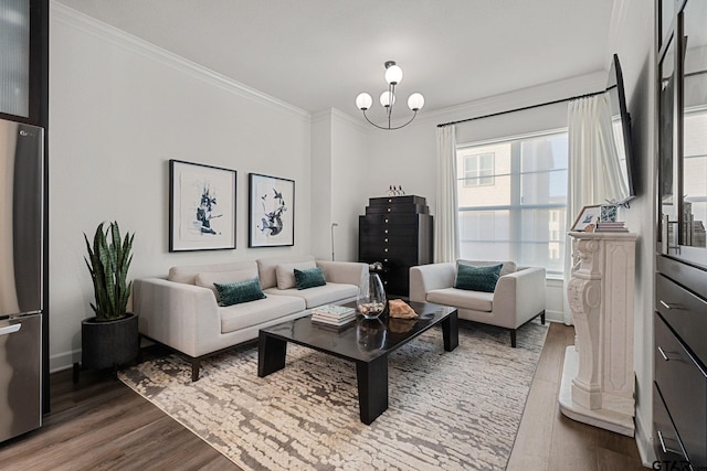 living room with hardwood / wood-style floors, a notable chandelier, and ornamental molding