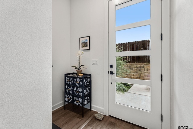 doorway with dark hardwood / wood-style floors