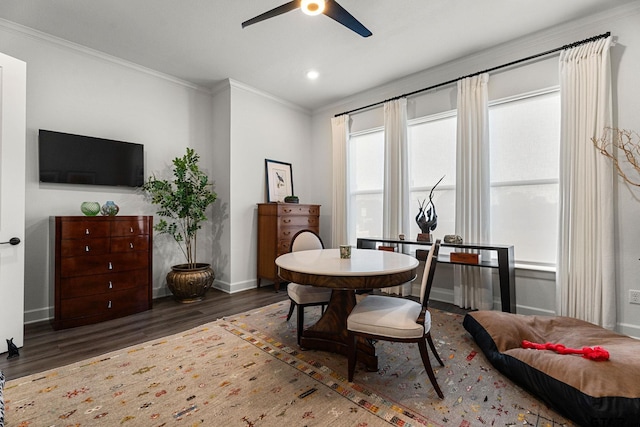 interior space with ceiling fan, ornamental molding, and dark wood-type flooring