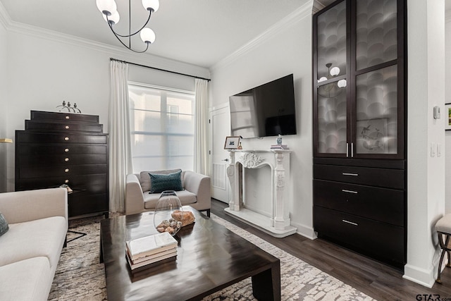 living room with a notable chandelier, dark hardwood / wood-style flooring, and ornamental molding