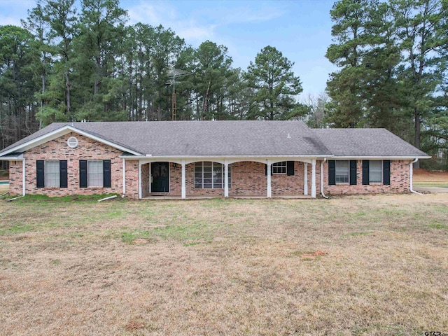 3805 N US Highway 271, Gilmer, TX 75644 - ranch-style home with brick siding, a front yard, and a shingled roof