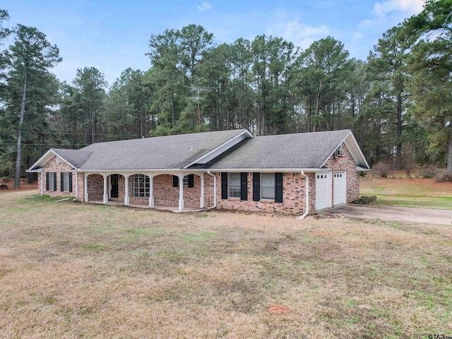 3805 N US Highway 271, Gilmer, TX 75644 - ranch-style home featuring an attached garage, covered porch, concrete driveway, a front yard, and brick siding