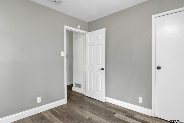 1523 Austin Dr, Tyler, TX 75701 - unfurnished bedroom featuring wood finished floors and baseboards
