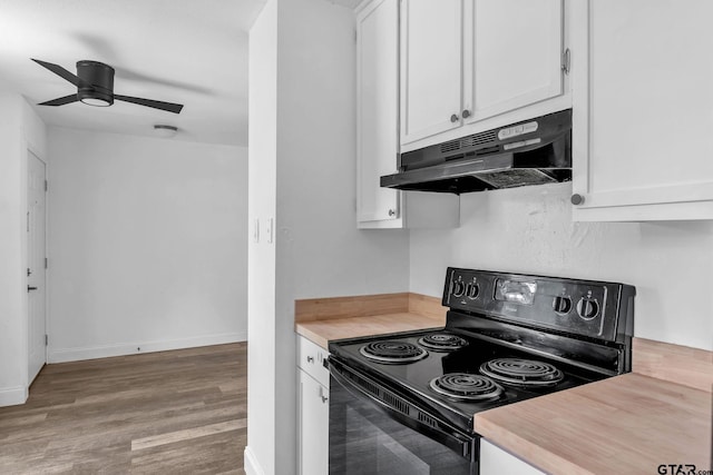 1523 Austin Dr, Tyler, TX 75701 - kitchen featuring black range with electric cooktop, under cabinet range hood, wood finished floors, white cabinets, and ceiling fan