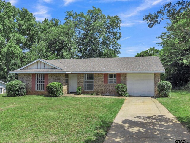 1523 Austin Dr, Tyler, TX 75701 - ranch-style house with brick siding, driveway, a garage, and a front lawn