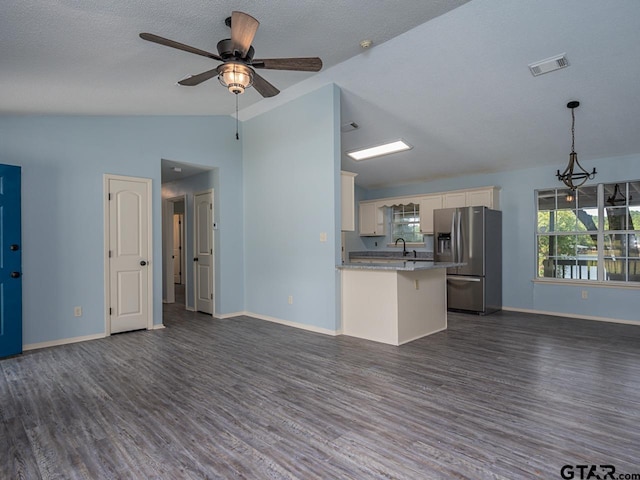 15509 Cedar Bay Dr, Bullard, TX 75757 - kitchen featuring dark wood-style flooring, stainless steel refrigerator with ice dispenser, visible vents, lofted ceiling, and open floor plan
