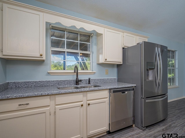 15509 Cedar Bay Dr, Bullard, TX 75757 - kitchen with stainless steel appliances, a healthy amount of sunlight, a sink, and wood finished floors