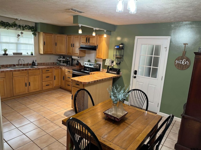 kitchen with sink, wooden counters, a textured ceiling, light tile patterned floors, and stainless steel electric stove