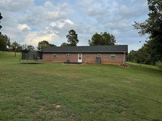 exterior space with a lawn and a trampoline