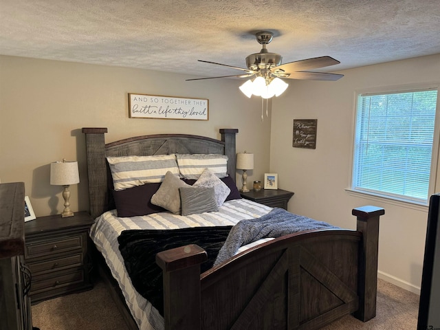 bedroom with carpet, a textured ceiling, and ceiling fan