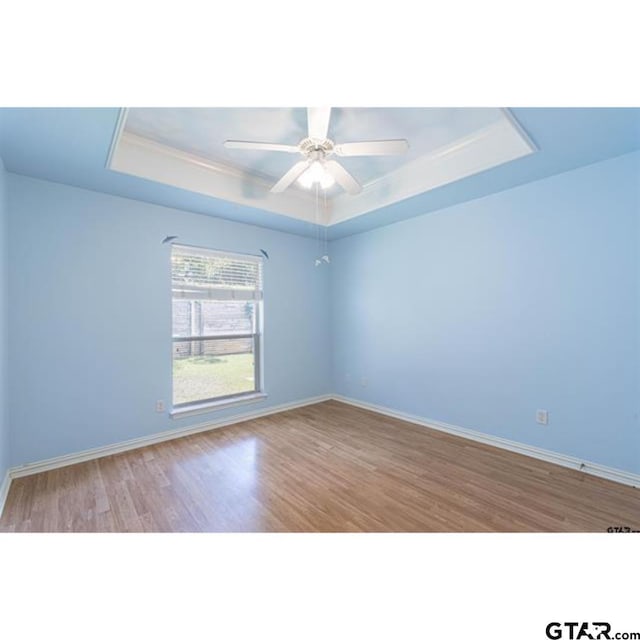 2060 Rana Park, Flint, TX 75762 - empty room with a raised ceiling, wood finished floors, and a ceiling fan
