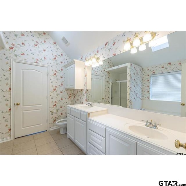 2060 Rana Park, Flint, TX 75762 - full bath with wallpapered walls, double vanity, vaulted ceiling, a shower stall, and tile patterned floors