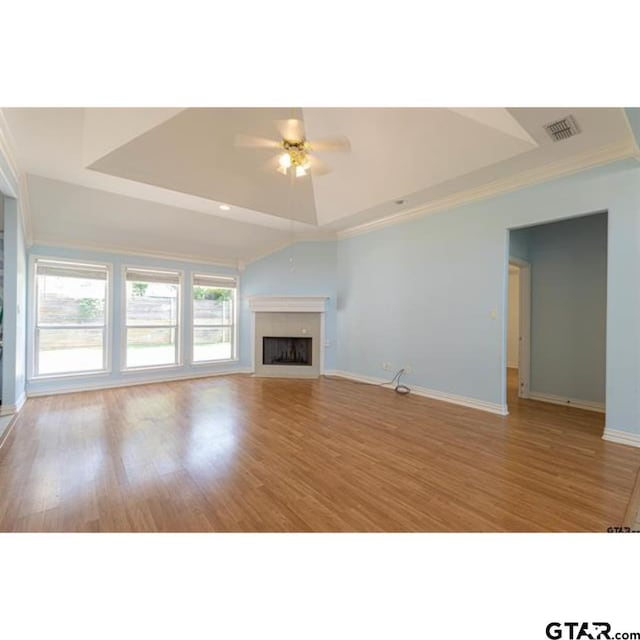2060 Rana Park, Flint, TX 75762 - unfurnished living room with a raised ceiling, a fireplace, wood finished floors, ornamental molding, and a ceiling fan