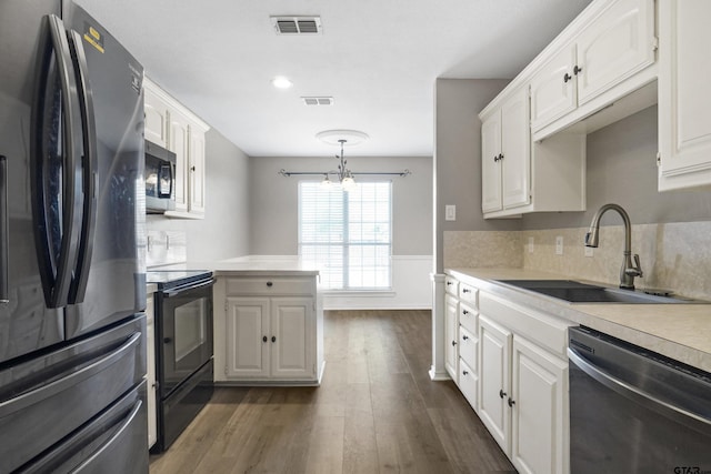 kitchen with sink, white cabinets, and black appliances